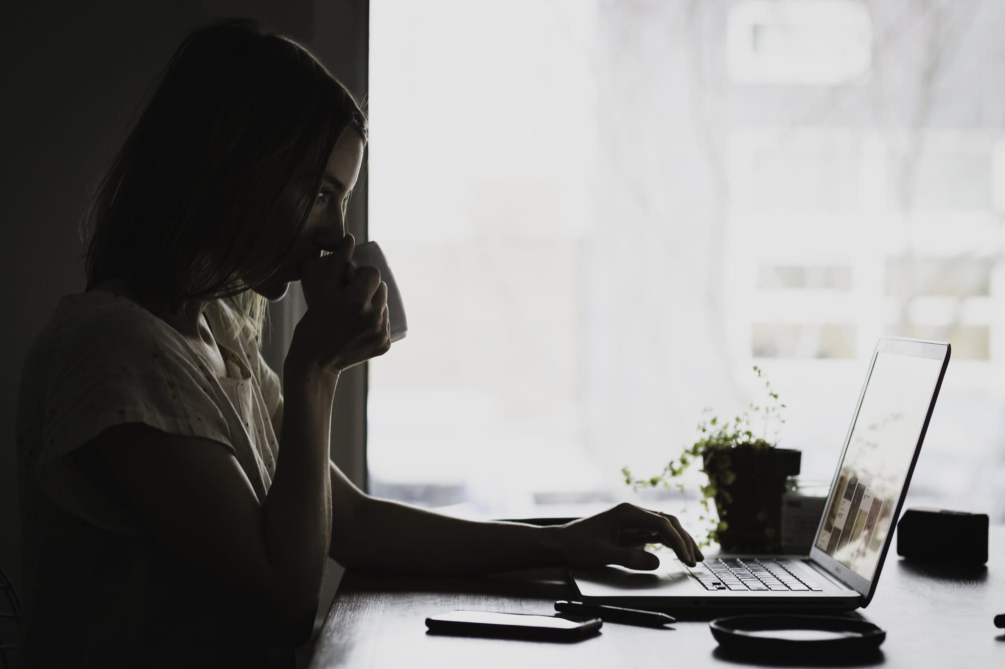 A tired business owner at a laptop in a dim room